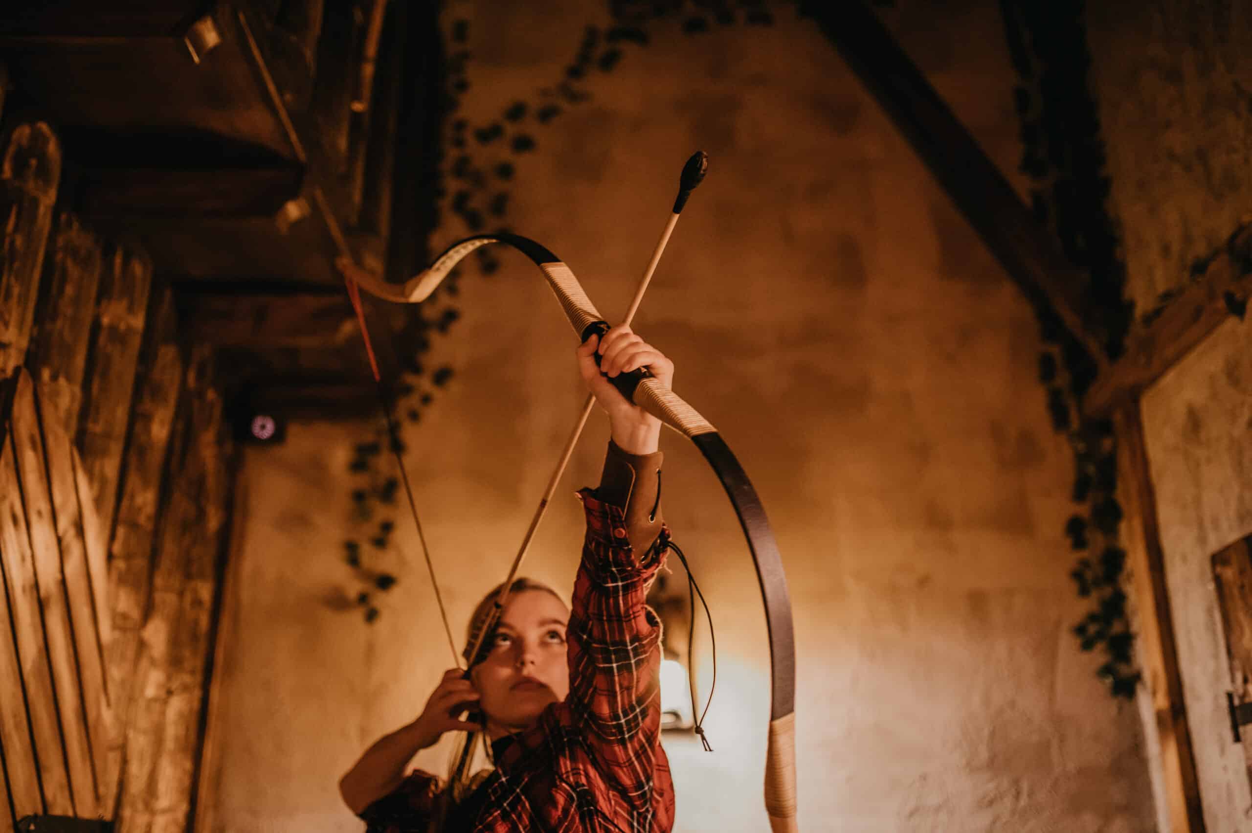 Archery game at Mastermind Escape Room in Bern, featuring an indoor setting with wooden decor.