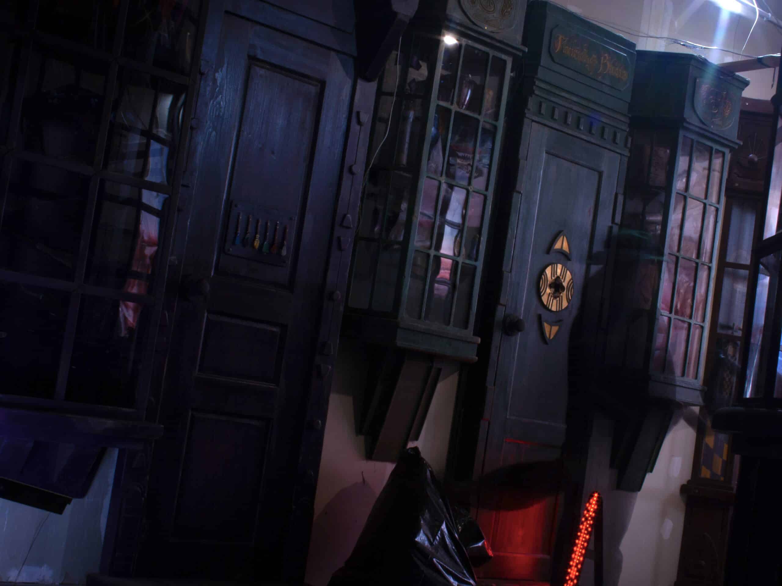 A dark, immersive escape room environment with wooden furniture and mysterious glowing elements.